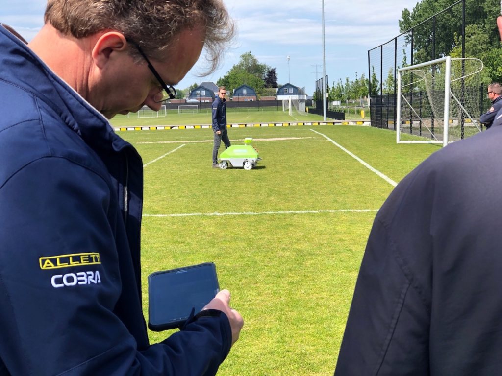 Arjen Spek with the Intelligent One robot to line mark sports fields